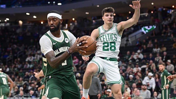 Dec 11, 2025; Milwaukee, Wisconsin, USA; Milwaukee Bucks forward Bobby Portis (9) grabs a rebound against Boston Celtics forward Hugo Gonzalez (28) in the fourth quarter at Fiserv Forum. Mandatory Credit: Benny Sieu-Imagn Images