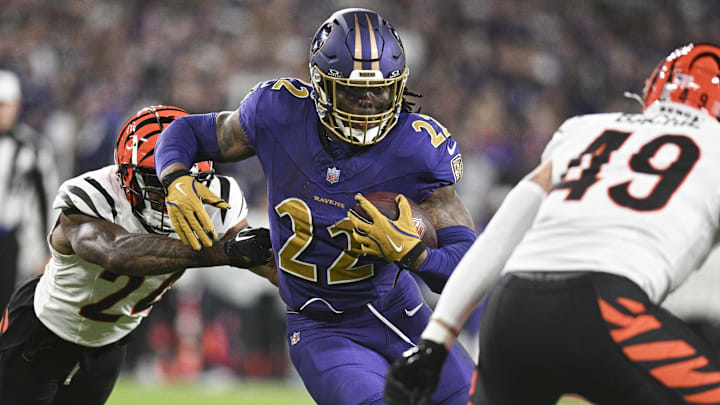 Nov 7, 2024; Baltimore, Maryland, USA; Baltimore Ravens running back Derrick Henry (22) rushes as Cincinnati Bengals safety Jordan Battle (27) and linebacker Joe Bachie (49) defends during the second half   at M&T Bank Stadium. Mandatory Credit: Tommy Gilligan-Imagn Images