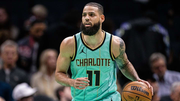 Jan 24, 2025; Charlotte, North Carolina, USA; Charlotte Hornets forward Cody Martin (11) brings the ball up court against the Portland Trail Blazers during the first quarter at Spectrum Center. Mandatory Credit: Scott Kinser-Imagn Images