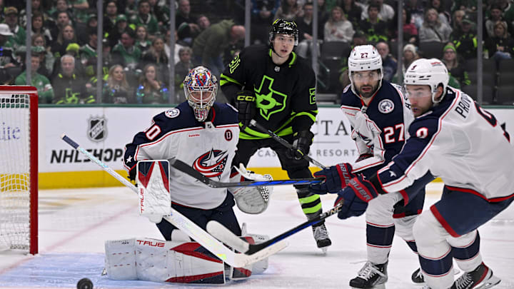 Feb 2, 2025; Dallas, Texas, USA; Columbus Blue Jackets goaltender Elvis Merzlikins (90) and center Zachary Aston-Reese (27) and Dallas Stars left wing Jason Robertson (21) in action during the game between the Dallas Stars and the Columbus Blue Jackets at American Airlines Center. Mandatory Credit: Jerome Miron-Imagn Images