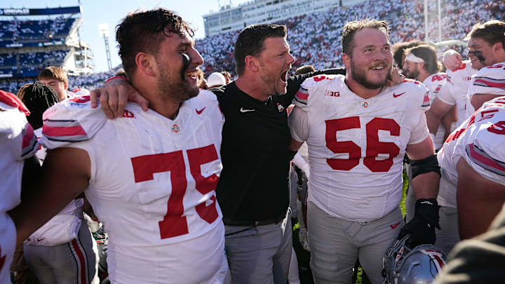 Ohio State Buckeyes offensive line coach Justin Frye celebrates with offensive linemen Carson Hinzman (75) and Seth McLaughlin (56) following the 20-13 win over the Penn State Nittany Lions in NCAA football game at Beaver Stadium in University Park, Pa. on Saturday, Nov. 2, 2024.