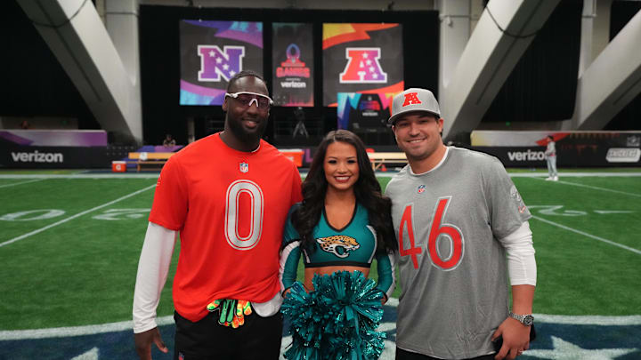 Feb 2, 2026; San Francisco, CA, USA; Jacksonville Jaguars linebacker Devin Lloyd (0) and long snapper Ross Matiscik (46) pose with Jaguars cheerleader Carolina at the NFL Flag Fieldhouse at Moscone Center South Building. Mandatory Credit: Kirby Lee-Imagn Images