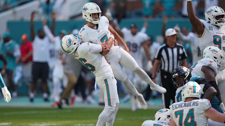 Miami Dolphins punter Jake Bailey (16) lifts Miami Dolphins place kicker Jason Sanders (7) after his game winning field goal against the Jacksonville Jaguars at Hard Rock Stadium.