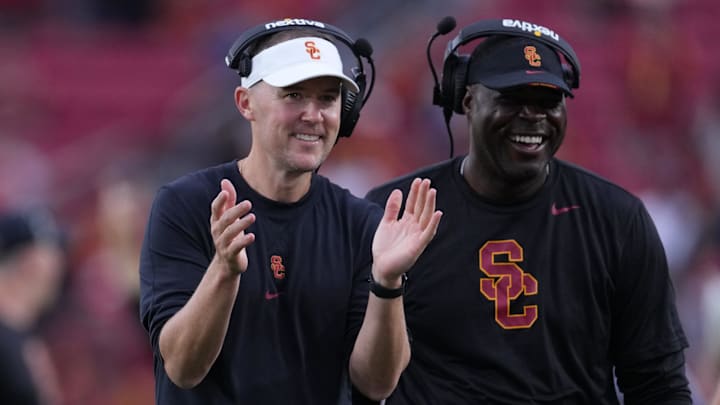 Sep 2, 2023; Los Angeles, California, USA; Southern California Trojans head coach Lincoln Riley (leff) and wide receivers coach Dennis Simmons react against the Nevada Wolf Pack.