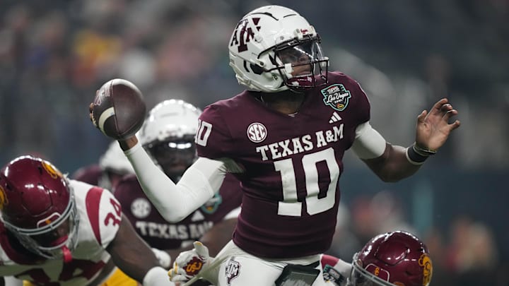 Dec 27, 2024; Las Vegas, NV, USA; Texas A&M Aggies quarterback Marcel Reed (10) throws the ball against Southern California Trojans cornerback John Humphrey (19) in the first half at Allegiant Stadium. 