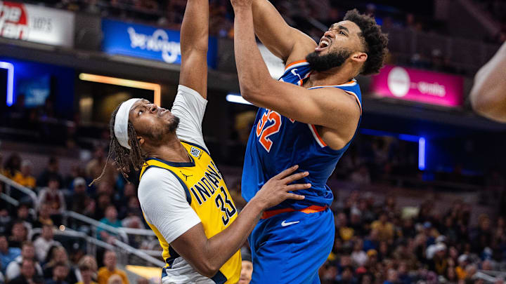 Nov 10, 2024; Indianapolis, Indiana, USA; New York Knicks center Karl-Anthony Towns (32) shoots the ball while Indiana Pacers center Myles Turner (33) defends in the second half at Gainbridge Fieldhouse. Mandatory Credit: Trevor Ruszkowski-Imagn Images
