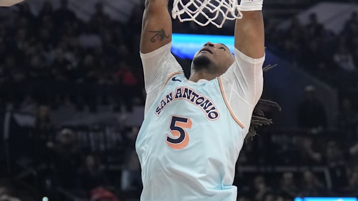 Nov 21, 2024; San Antonio, Texas, USA; San Antonio Spurs guard Stephon Castle (5) dunks during the second half against the Utah Jazz at Frost Bank Center. Mandatory Credit: Scott Wachter-Imagn Images