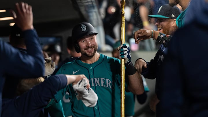 Seattle Mariners catcher Cal Raleigh (29) celebrates in the dugout after hitting a solo home run during the fourth inning against the Oakland Athletics at T-Mobile Park in 2024.