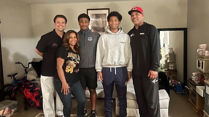 Taylor Daniels and his family with Gophers CBs coach Nick Monroe. Taylor Daniels and his family with Gophers CBs coach Nick Monroe.