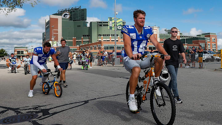 Seattle Seahawks quarterback Sam Darnold (14) rides a bicycle to a joint practice with the Green Bay Packers on Thursday, August 21, 2025, at Lambeau Field in Green Bay, Wis. Seattle Seahawks quarterback Sam Darnold (14) rides a bicycle to a joint practice with the Green Bay Packers on Thursday, August 21, 2025, at Lambeau Field in Green Bay, Wis.