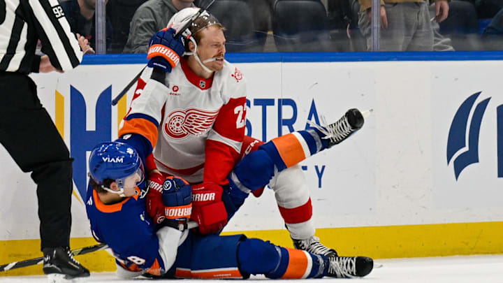 Oct 23, 2025; Elmont, New York, USA;  New York Islanders defenseman Matthew Schaefer (48) wrestles with Detroit Red Wings center Mason Appleton (22) during the third period at UBS Arena. Mandatory Credit: Dennis Schneidler-Imagn Images