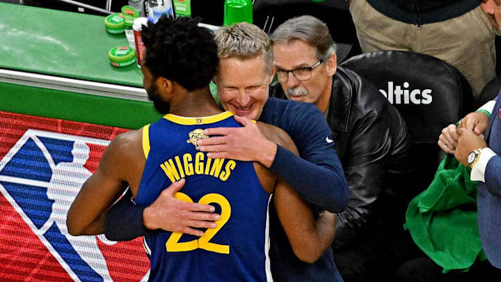 Golden State Warriors forward Andrew Wiggins (22) hugs head coach Steve Kerr.