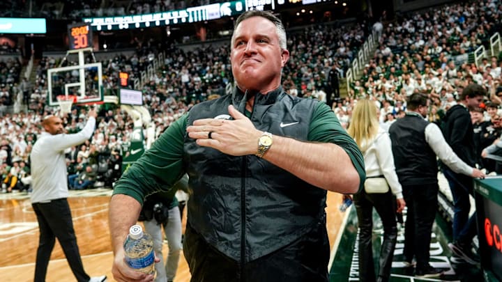 Michigan State's new football coach Pat Fitzgerald pats his heart at the crowd in attendance for the Spartans basketball game against Iowa on Tuesday, Dec. 2, 2025, at the Breslin Center in East Lansing.