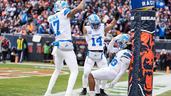 Detroit Lions running back Jahmyr Gibbs (26) celebrates a touchdown with Amon-Ra St. Brown (14) and Tim Patrick (17).