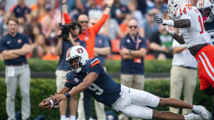 Auburn Tigers quarterback Deuce Knight (9) dives in the end zone for a touchdown as Auburn Tigers take on Mercer Bears at Jordan-Hare Stadium in Auburn, Ala. on Saturday, Nov. 22, 2025. Auburn Tigers lead the Mercer Bears 35-17 at halftime. Auburn Tigers quarterback Deuce Knight (9) dives in the end zone for a touchdown as Auburn Tigers take on Mercer Bears at Jordan-Hare Stadium in Auburn, Ala. on Saturday, Nov. 22, 2025. Auburn Tigers lead the Mercer Bears 35-17 at halftime.