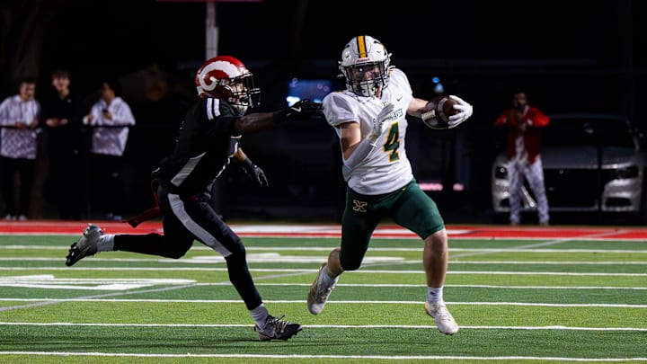St. Xavier got around the corner for positive yardage during first half action as the St. X Tigers and Manual Crimsons faced off in KHSAA football action on Friday, Oct. 10, 2025. St. Xavier got around the corner for positive yardage during first half action as the St. X Tigers and Manual Crimsons faced off in KHSAA football action on Friday, Oct. 10, 2025.