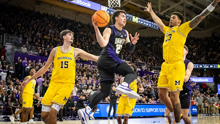 JJ Mandaquit drives the baseline against Michigan. 