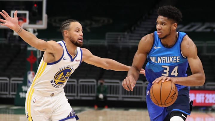 Dec 25, 2020; Milwaukee, WI, USA; Milwaukee Bucks forward Giannis Antetokounmpo (34) dribbles the ball against Golden State Warriors guard Stephen Curry (30) during a NBA game at the Bradley Center. Mandatory Credit: Nick Monroe/Handout Photo-Imagn Images