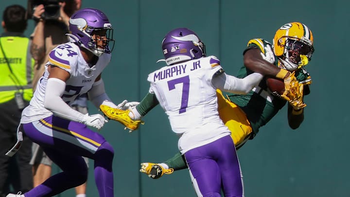 Green Bay Packers wide receiver Jayden Reed (11) catches a touchdown pass against the Minnesota Vikings on Sept. 29.