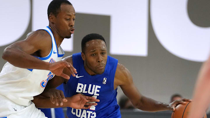 Dec 22, 2021; Las Vegas, NV, USA; Delaware Blue Coats guard Jared Brownridge (24) dribbles against Oklahoma City Blue forward Scotty Hopson (32) during the fourth quarter at Mandalay Bay Convention Center. Mandatory Credit: Stephen R. Sylvanie-Imagn Images