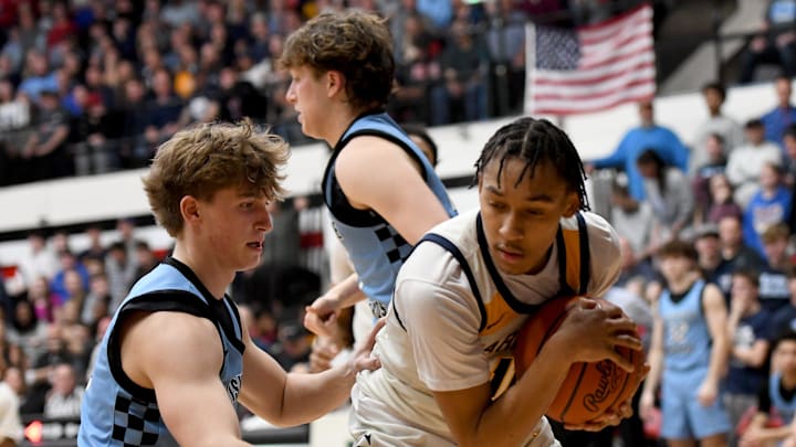 Garfield Heights' Marcus Johnson (right) covers up a rebound as Louisville's Ashton Marshall defends during an OHSAA Division III boys basketball state semifinal at Canton Memorial Field House on Sunday, March 16, 2025. Garfield Heights' Marcus Johnson (right) covers up a rebound as Louisville's Ashton Marshall defends during an OHSAA Division III boys basketball state semifinal at Canton Memorial Field House on Sunday, March 16, 2025.