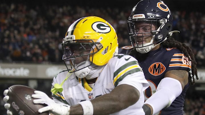 Jan 10, 2026; Chicago, IL, USA; Green Bay Packers wide receiver Jayden Reed (11) scores a touchdown against Chicago Bears linebacker Tremaine Edmunds (49) in an NFC Wild Card Round game at Soldier Field.