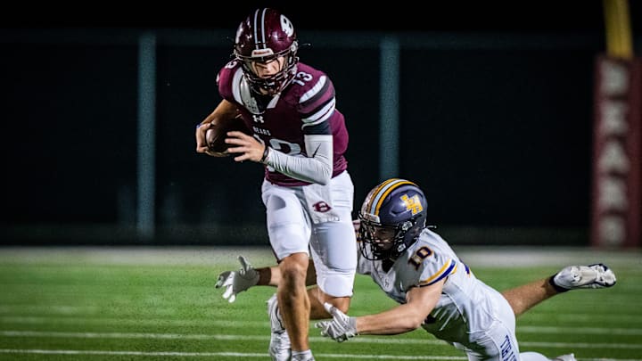 Bastrop quarterback Weston Nielson (13) carries the ball as Liberty Hill linebacker Garrett Lindgren (10) dives to tackle him in the first quarter of the game in Bastrop between the Bears and the Panthers, Nov. 8, 2024. Both teams go into the game undefeated in district play with the district championship on the line.