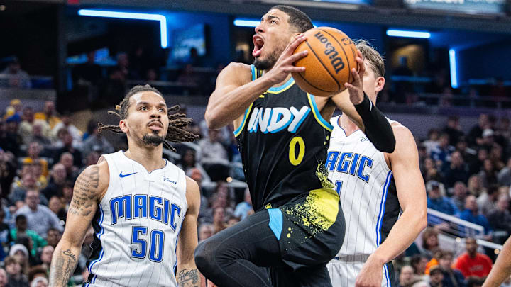 Dec 23, 2023; Indianapolis, Indiana, USA; Indiana Pacers guard Tyrese Haliburton (0) shoots the ball while Orlando Magic guard Cole Anthony (50) defends in the first half at Gainbridge Fieldhouse. Mandatory Credit: Trevor Ruszkowski-Imagn Images