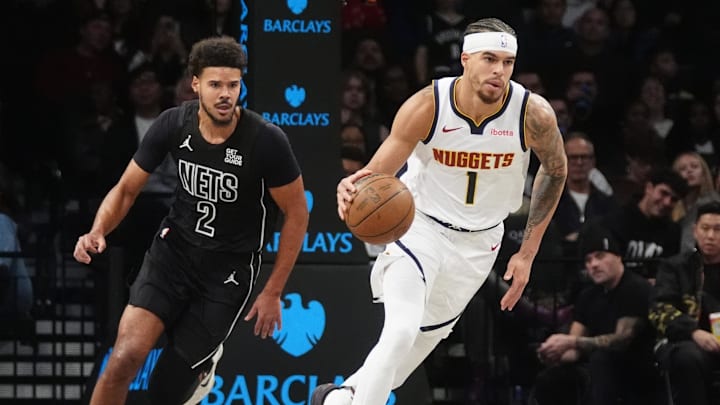 Oct 29, 2024; Brooklyn, New York, USA; Denver Nuggets small forward Michael Porter Jr. (1) dribbles the ball up the court past Brooklyn Nets small forward Cameron Johnson (2) during the first half at Barclays Center. Mandatory Credit: Gregory Fisher-Imagn Images
