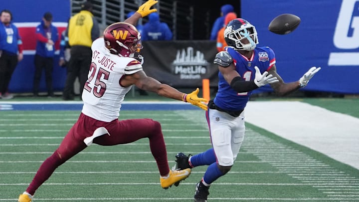 Nov 3, 2024; East Rutherford, New Jersey, USA; New York Giants wide receiver Malik Nabers (1) can't quite hang on to a pass but Washington Commanders cornerback Benjamin St-Juste (25) was called for pass interference during the second half at MetLife Stadium.  