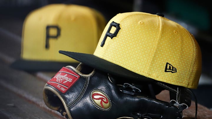 Sep 16, 2023; Pittsburgh, Pennsylvania, USA;  Pittsburgh Pirates hats and gloves in the dugout against the New York Yankees during the sixth inning at PNC Park. Mandatory Credit: Charles LeClaire-Imagn Images