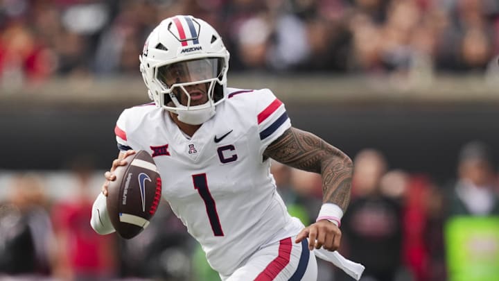 Nov 15, 2025; Cincinnati, Ohio, USA;  Arizona Wildcats quarterback Noah Fifita (1) runs with the ball as he looks to pass against the Cincinnati Bearcats in the first half at Nippert Stadium. Mandatory Credit: Aaron Doster-Imagn Images
