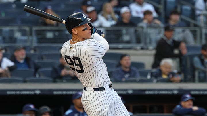 Apr 27, 2025; Bronx, New York, USA;  New York Yankees right fielder Aaron Judge (99) hits a solo home run during the sixth inning against the Toronto Blue Jays at Yankee Stadium.