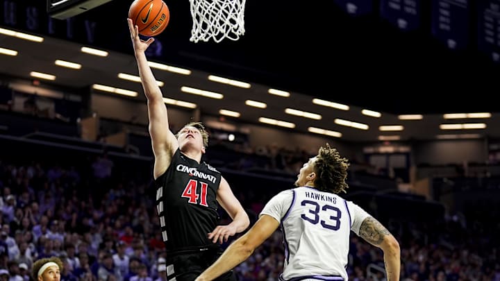Dec 30, 2024; Manhattan, Kansas, USA; Cincinnati Bearcats guard Simas Lukosius (41) shoots against Kansas State Wildcats guard Coleman Hawkins (33) during the first half at Bramlage Coliseum. Mandatory Credit: Jay Biggerstaff-Imagn Images