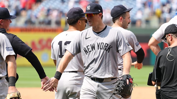 Jul 31, 2024; Philadelphia, Pennsylvania, USA;  New York Yankees third base DJ LeMahieu (26) shakes hands with teammates after a victory against the Philadelphia Phillies at Citizens Bank Park. Mandatory Credit: Bill Streicher-Imagn Images