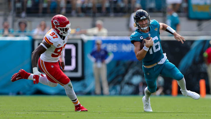 Sep 17, 2023; Jacksonville, Florida, USA;  Jacksonville Jaguars quarterback Trevor Lawrence (16) runs with the ball chased by Kansas City Chiefs defensive end Felix Anudike-Uzomah (97) in the second quarter at EverBank Stadium. Mandatory Credit: Nathan Ray Seebeck-USA TODAY Sports