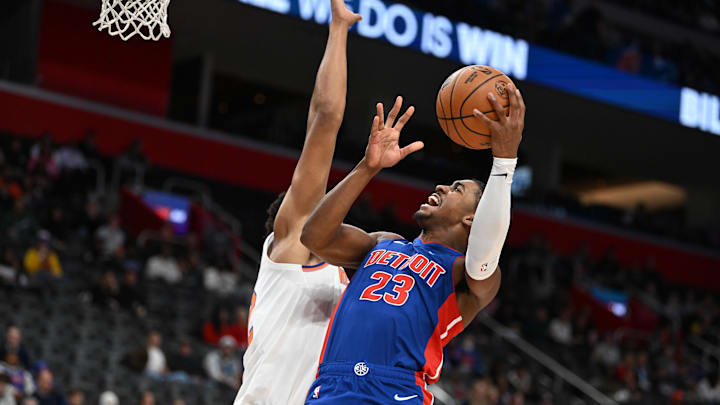 Nov 1, 2024; Detroit, Michigan, USA; Detroit Pistons guard Jaden Ivey (23) drives to the basket against New York Knicks center Karl-Anthony Towns (32) in the second quarter at Little Caesars Arena. Mandatory Credit: Lon Horwedel-Imagn Images