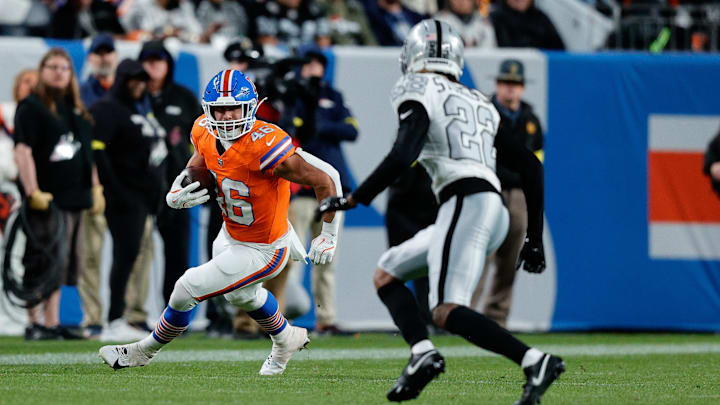 Nov 6, 2025; Denver, Colorado, USA; Denver Broncos fullback Adam Prentice (46) runs the ball against Las Vegas Raiders cornerback Eric Stokes (22) in the third quarter at Empower Field at Mile High. Mandatory Credit: Isaiah J. Downing-Imagn Images