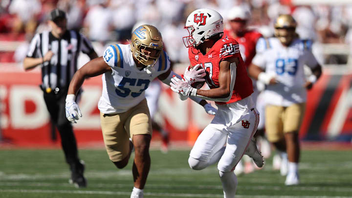 Sep 23, 2023; Salt Lake City, Utah, USA; UCLA Bruins linebacker Darius Muasau (53) prepares to tackle Utah Utes wide receiver Devaughn Vele (17) in the second half at Rice-Eccles Stadium. Mandatory Credit: Rob Gray-Imagn Images