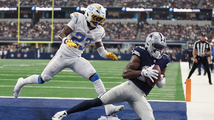 Aug 24, 2024; Arlington, Texas, USA; Dallas Cowboys wide receiver Ryan Flournoy (18) catches a touchdown pass against Los Angeles Chargers cornerback Matt Hankins (23)  in the second quarter at AT&T Stadium. Mandatory Credit: Tim Heitman-Imagn Images