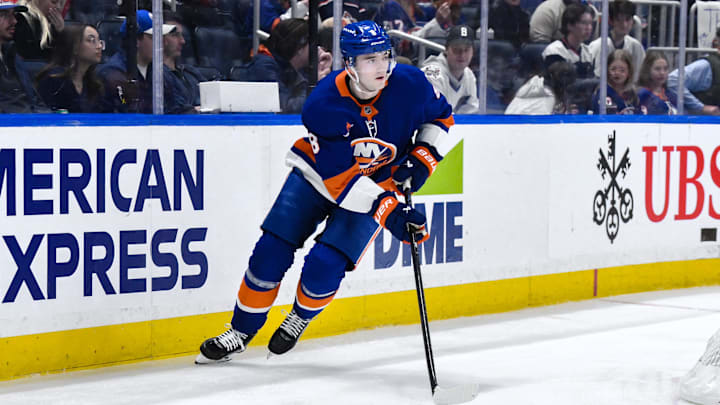 Apr 15, 2025; Elmont, New York, USA; New York Islanders defenseman Noah Dobson (8) skates with the puck during the third period against the Washington Capitals at UBS Arena. Mandatory Credit: John Jones-Imagn Images