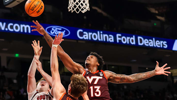 Dec 2, 2025; Columbia, S.C.; Virginia Tech forward Amani Hansberry (13) grabs a rebound over South Carolina guard Eli Ellis (15).