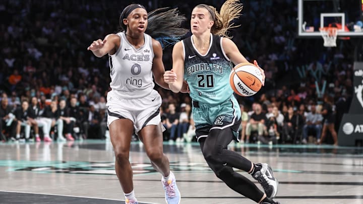 Jul 8, 2025; Brooklyn, New York;  New York Liberty guard Sabrina Ionescu (20) drives past Las Vegas Aces guard Jackie Young (0) in the third quarter at Barclays Center. 
