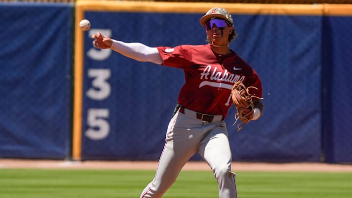 May 21, 2025; Hoover, AL, USA; Alabama shortstop Justin Lebron (1) throws to first but a fielding muff allowed the Tennessee batter to arrive safely in the second round of the SEC Baseball Tournament at the Hoover Met.