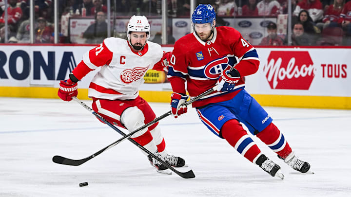 Dec 2, 2023; Montreal, Quebec, CAN; Montreal Canadiens right wing Joel Armia (40) plays the puck against Detroit Red Wings center Dylan Larkin (71) during the first period at Bell Centre. Mandatory Credit: David Kirouac-Imagn Images