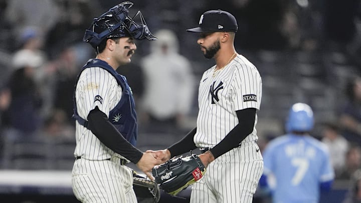 Apr 14, 2025; Bronx, New York, USA; New York Yankees catcher Austin Wells (28) and pitcher Devin Williams (38) shake hands to celebrate the victory after the game against the Kansas City Royals at Yankee Stadium.