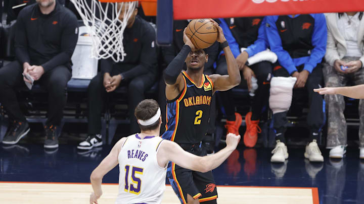 Apr 6, 2025; Oklahoma City, Oklahoma, USA; Oklahoma City Thunder guard Shai Gilgeous-Alexander (2) shoots over Los Angeles Lakers guard Austin Reaves (15) during the first quarter at Paycom Center. Mandatory Credit: Alonzo Adams-Imagn Images