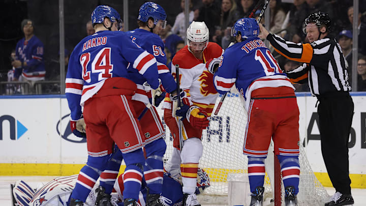 Feb 12, 2024; New York, New York, USA; Calgary Flames center Kevin Rooney (21) steps over New York