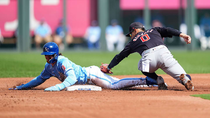 Sep 2, 2024; Kansas City, Missouri, USA; Kansas City Royals designated hitter Bobby Witt Jr. (7) steals second base against Cleveland Guardians second baseman Andres Gimenez (0) during the first inning at Kauffman Stadium. Mandatory Credit: Jay Biggerstaff-Imagn Images