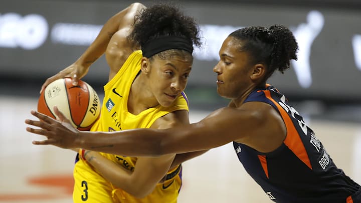 Sep 17, 2020; Palmetto, Florida, USA; Connecticut Sun forward Alyssa Thomas (25) reaches in on Los Angeles Sparks forward Candace Parker (3) during the first half at the FELD entertainment complex. Mandatory Credit: Reinhold Matay-Imagn Images